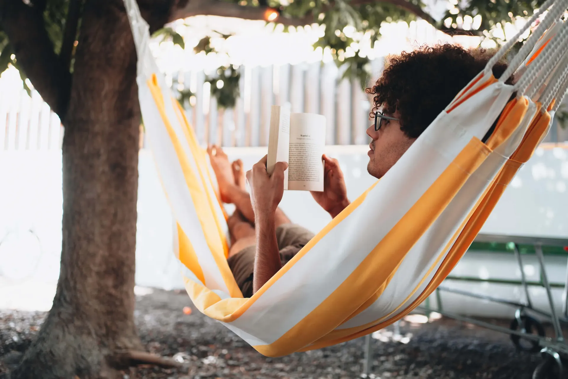Guest reading in a hammock in the garden at Cactus Coliving